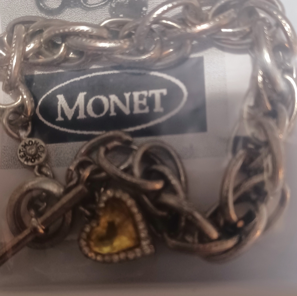 Signedvintage monet silver chain bracelet with a amber colored heart shapedcharm